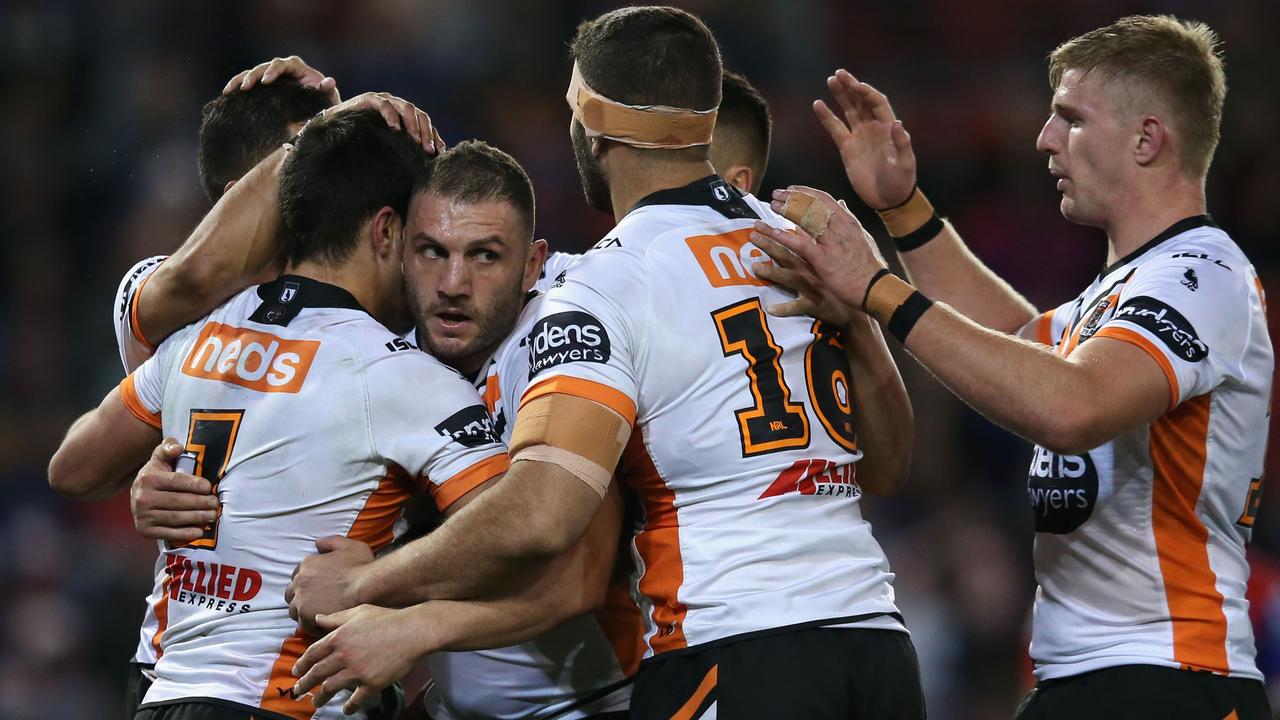 Robbie Farah celebrates a try with teammates in his 300th game.