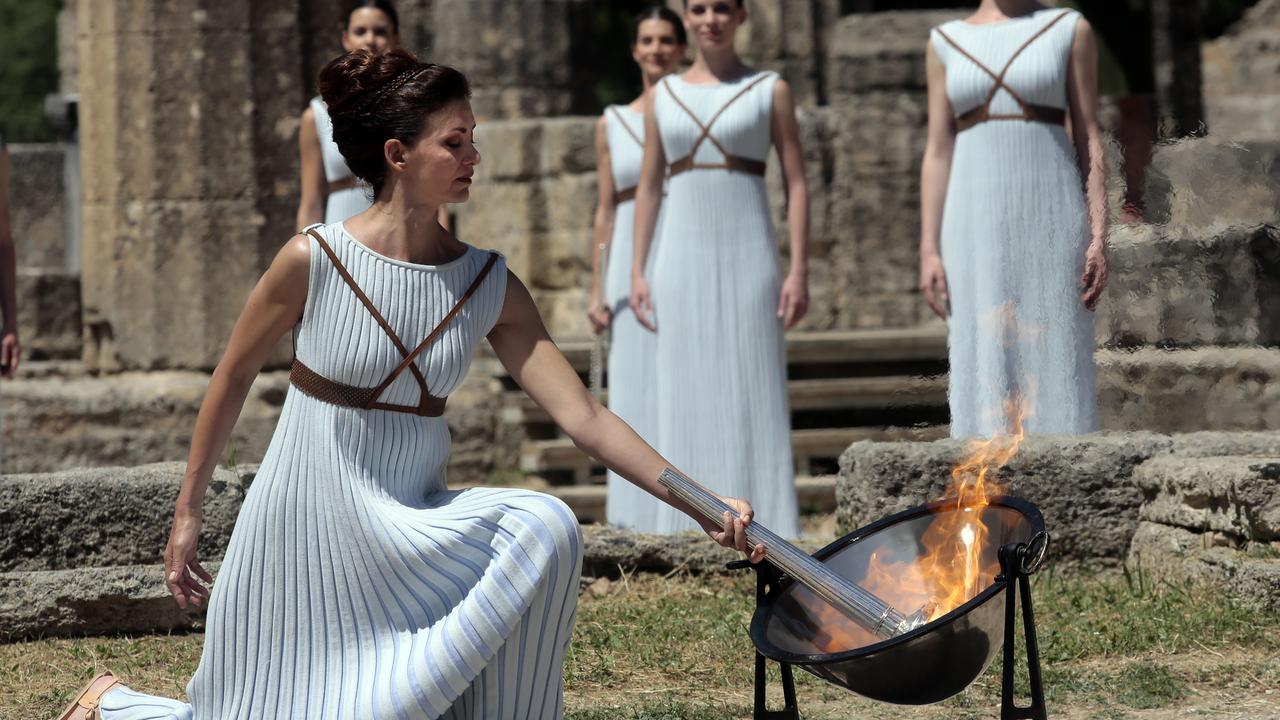 Actor Katerina Lechou, acting the high priestess, lights the Olympic Torch in Olympia, Greece in a 2016 rehearsal ahead of the lighting ceremony. Picture: Getty Images