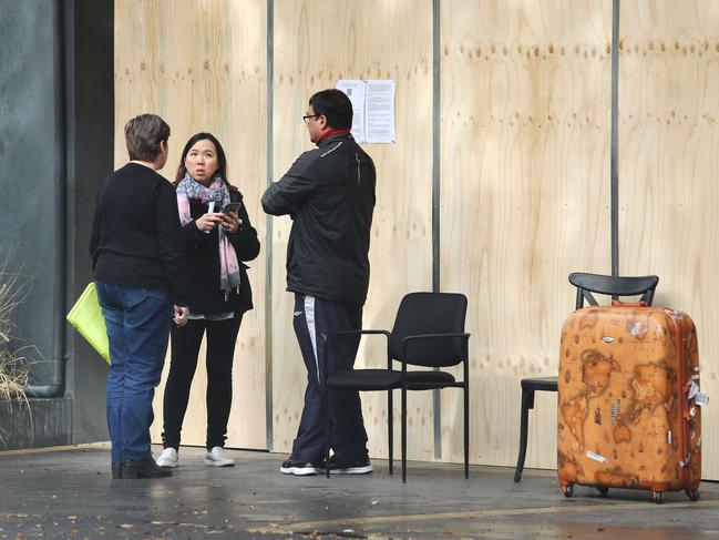 17/6/19: Residents talk to representatives of Mascot Towers before going in to collect their necessary items. John Feder/The Australian.