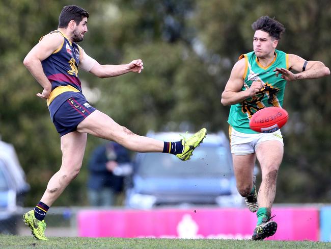 Nick Batsanis of Doncaster East kicks past Aaron Beddoes of Mooroolbark in 2017. Picture: Hamish Blair