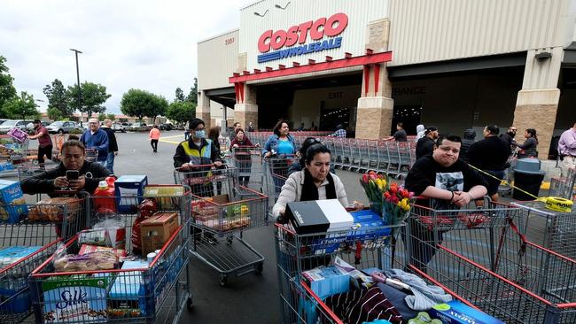 Shoppers stock up at a Los Angeles Costco as lenders tighten access to credit.