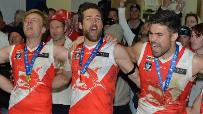 Nepean football league Grand Final: Sorrento v Frankston at Frankston Park. The Sharks went into the grand final as favourites and delivered another flag with a comfortable win over the Bombers. (L-R) Aaron Paxton, Troy Schwarze and Chris Dawes belt out the song. Picture: AAP/ Chris Eastman