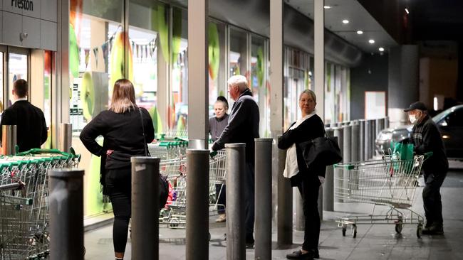 Customers wait for Woolworths in Preston to open its doors at 7am. Picture: David Geraghty / The Australian.