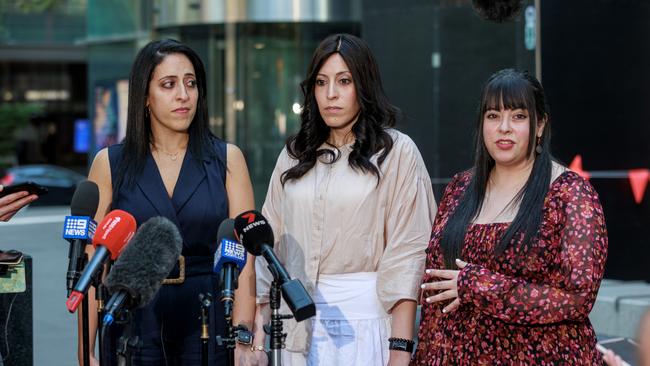 Sisters Elly Sapper, Nicole Meyer and Dassi Erlich held hands after the verdict was read out and said they were ready to move on with their lives. Picture: NCA NewsWire / David Geraghty