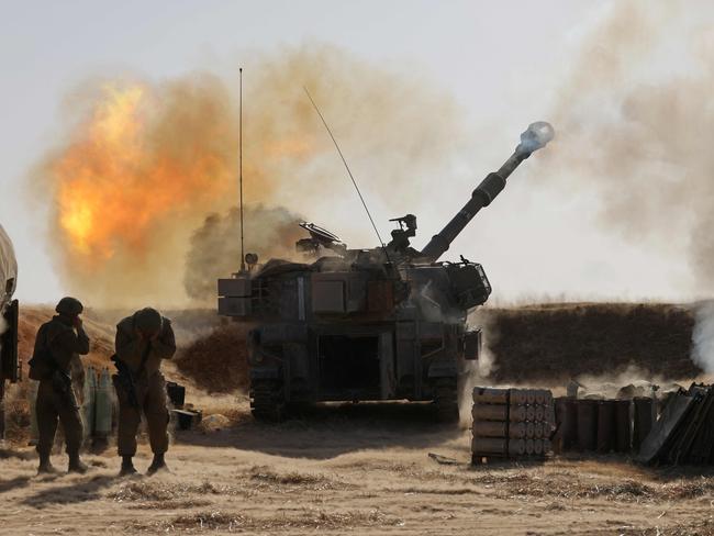 Israeli soldiers fire a 155mm self-propelled howitzer towards targets in the Gaza Strip from their position near the southern Israeli city of Sderot. Picture: AFP