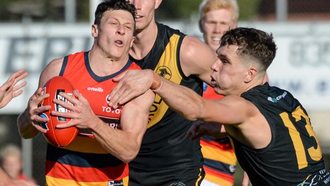 Glenelg’s Brady Searle takes Adelaide’s James Mathews high. Picture: Brenton Edwards