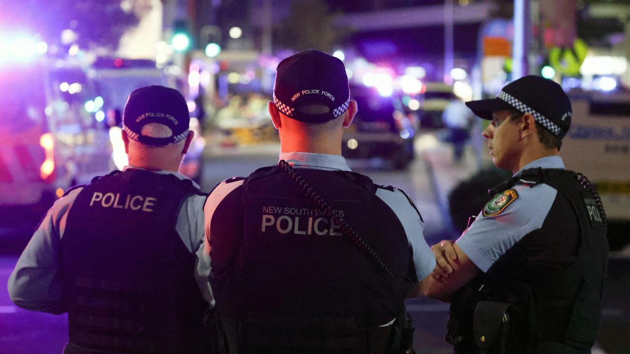 Police keep watch in front of the Westfield Bondi Junction shopping mall after a stabbing incident in Sydney on April 13, 2024. The number of people killed by a knife-wielding assailant in a Sydney shopping centre on April 13 has climbed to six, police said. (Photo by David GRAY / AFP)