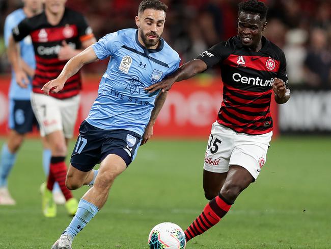 Sydney FC’s Anthony Caceres (left) and Western Sydney Wanderers’ Mohamed Adam compete for the ball on Saturday night. Picture: Getty Images