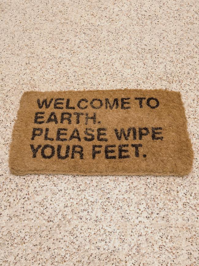 A mat designed by Gorrow welcomes guests.