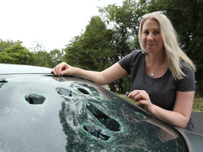 Clare O'Brien with her car which was damaged in the hail storm. Picture: Tim Hunter.