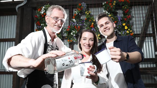 David Hunn, from Hunnington Distillery, left, serves up a taste to Georgia Press and Connor Bass during Ginuary. Picture: LUKE BOWDEN