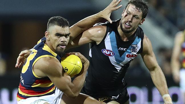 Tough work ... Charlie Cameron fends off Port skipper Travis Boak. Picture: Sarah Reed