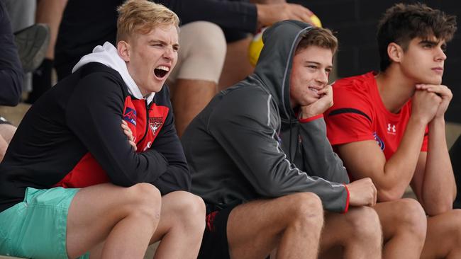 New rookie Tom Hird (left) watches on during Essendon’s clash with Geelong.