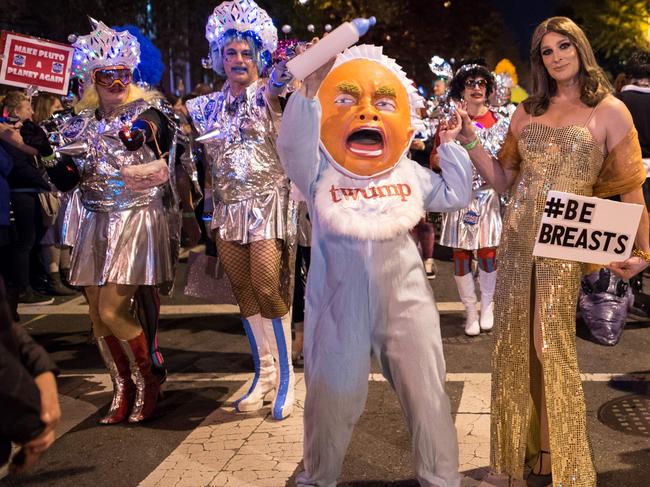 People dressed as Donald Trump and his wife Melania pose for a photo during the parade part of the 32nd annual High Heel Drag Race in Washington. Picture: AFP