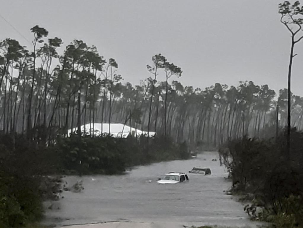 Rising waters cover cars on a road in Freeport in the Grand Bahamas. Picture: AFP