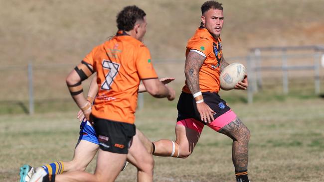 Tigers centre Brendon Hearne breaks clear as Cameron Williams looks on. Picture: Steve Montgomery