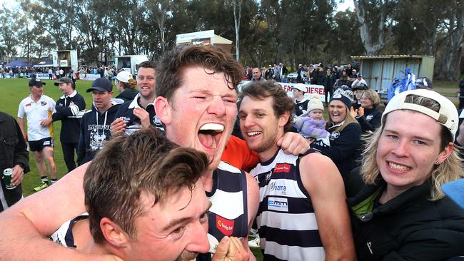 LBU ruckman Tyler Phillips, centre, celebrates with teammates after the grand final win. Picture Yuri Kouzmin