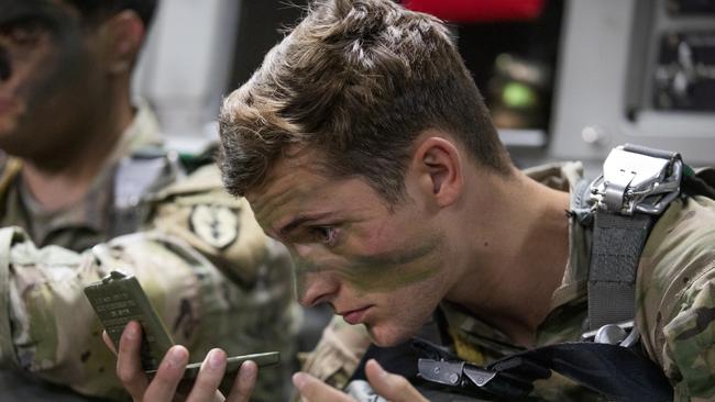 A soldier applies camouflage paint prior to a parachute drop from a Royal Australian Air Force C-17A Globemaster III aircraft, during Exercise Talisman Sabre 2021. Picture: ADF