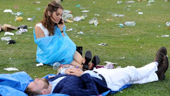 Punters enjoying themselves after the running of the Melbourne Cup, at Flemington Racecourse.