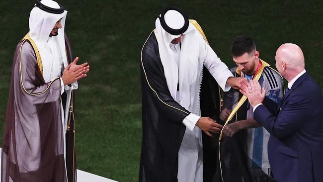 Lionel Messi of Argentina is presented with a traditional robe