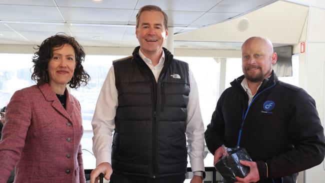 Transport Minister Michael Ferguson, with Derwent Ferry skipper Josh Newton and Alison Hetherington of the Bicycle Network on the ferry to mark 2 years in operation