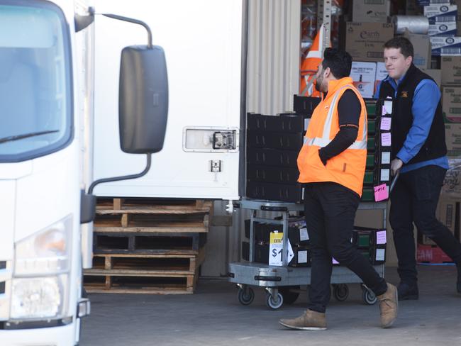 Strawberries are loaded into a truck at Klose's Foodland at Littlehampton on Monday after a needle was found in one of the berries sold at the supermarket on Sunday. Picture: AAP / Brenton Edwards