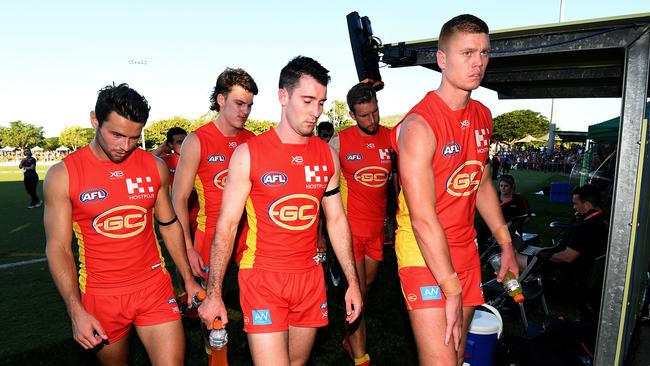 Suns players trudge from Riverway Stadium in Townsville in Saturday after losing to St Kilda. Picture: AAP