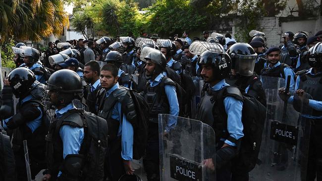 Riot polic cordon off a street as activists of right-wing religious Jamaat-e-Islami (JI) march toward the Sweden embassy during a demonstration in Islamabad on July 3, 2023, as they protest against the burning of the Koran outside a Stockholm mosque that outraged Muslims around the world. (Photo by Aamir QURESHI / AFP)