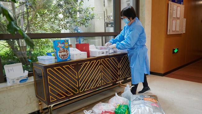 Limited access to food and daily necessities due to the imposed lockdown has forced people to resort to old ways of exchanging goods via bartering. Residents now either trade and deliver goods from one neighbour to another, or simply leave items in the building lobby, awaiting others to pick them up. Picture: AFP