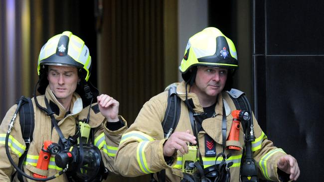 Fire crews inspecting the aftermath of the Spencer St fire. Picture: Andrew Henshaw