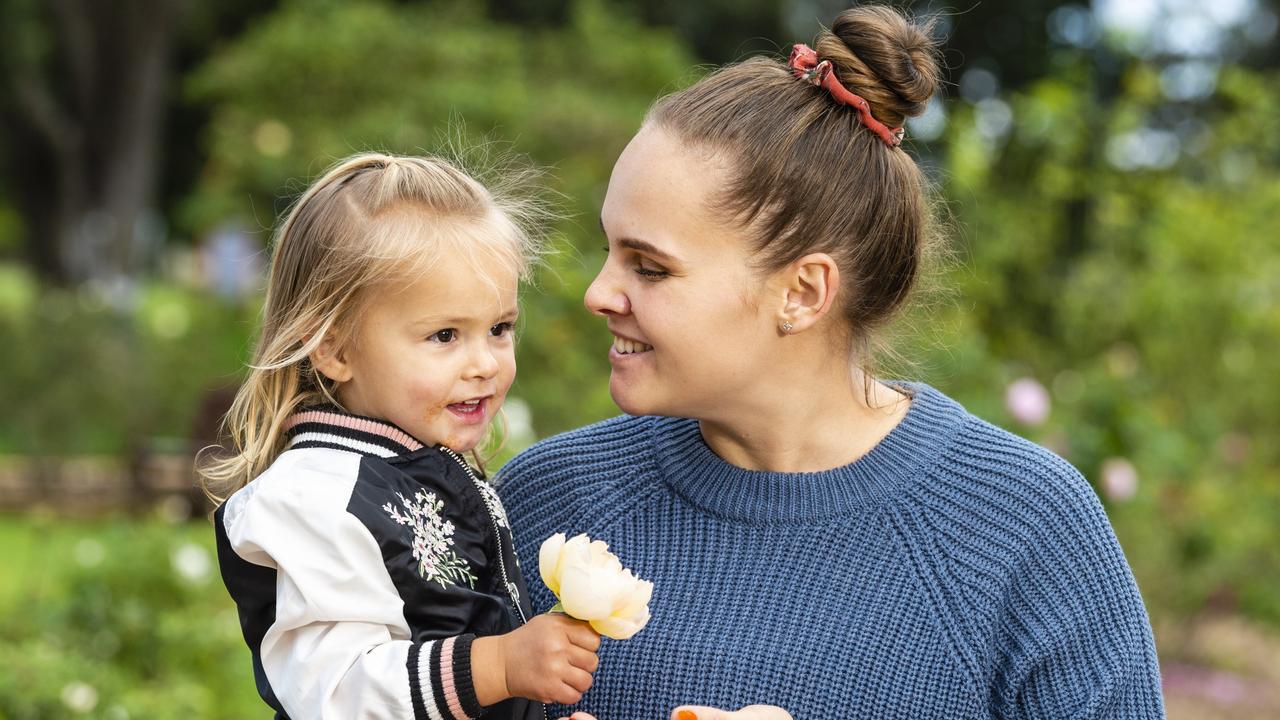 Eleisha Park is shown a rose by daughter Raegan on Mother's Day during celebrations in the Queensland State Rose Garden, Newtown Park, Sunday, May 8, 2022. Picture: Kevin Farmer