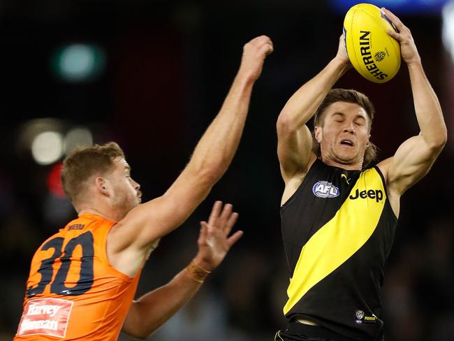 MELBOURNE, AUSTRALIA - MAY 15: Liam Baker of the Tigers and Matt Flynn of the Giants compete for the ball during the 2021 AFL Round 09 match between the Richmond Tigers and the GWS Giants at Marvel Stadium on May 15, 2021 in Melbourne, Australia. (Photo by Michael Willson/AFL Photos via Getty Images)