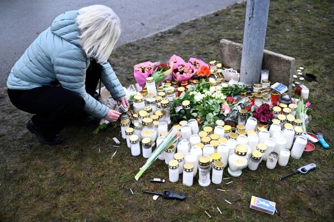 Tributes are paid at the education centre in the Swedish town of Orebro where 10 people were killed by a gunman who is believed to have shot himself