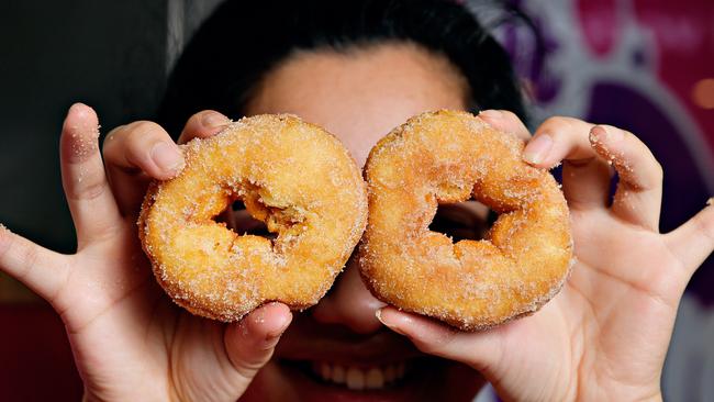 Fiona Sang prepares one of the last batches of cinnamon donuts as the store prepared to close its doors at Casuarina Square.