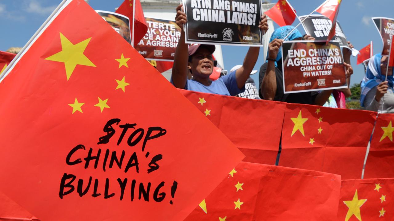 Activists hit out at China placards and flags at a protest in Manila this week. Picture: Ted Aljibe/AFP