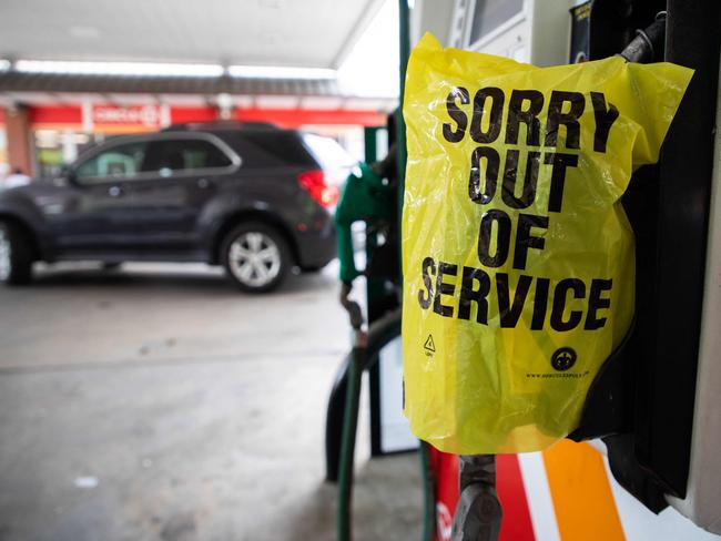 An "Out Of Service" bag covers a gas pump as cars continue line up for the chance to fill their cars. Picture: Logan Cyrus/AFP