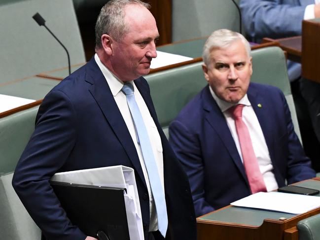 Former Australian Deputy Prime Minister Michael McCormack (right) reacts as Australian Deputy Prime Minister Barnaby Joyce arrives during House of Representatives Question Time at Parliament House in Canberra, Wednesday, June 23, 2021. (AAP Image/Lukas Coch) NO ARCHIVING