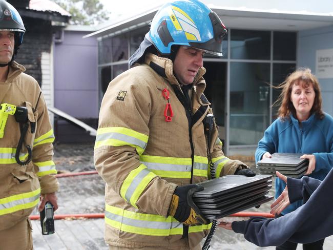 Laptops retrieved by Tasmania Fire Service and handed to school staff. Fire destroyed classrooms at Bowen Road Primary School at Moonah. Picture: Nikki Davis-Jones