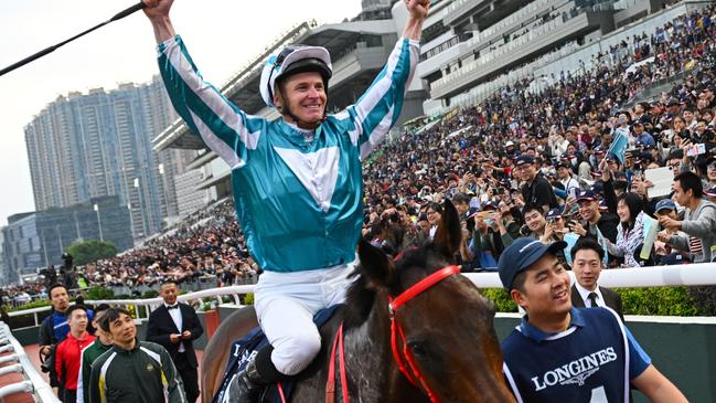 HONG KONG, CHINA - DECEMBER 08: James McDonald riding Romantic Warrior reacts with the crowd after winning Race 8, the Longines Hong Kong Cup during racing at Sha Tin Racecourse on December 08, 2024 in Hong Kong, China.  (Photo by Vince Caligiuri/Getty Images)