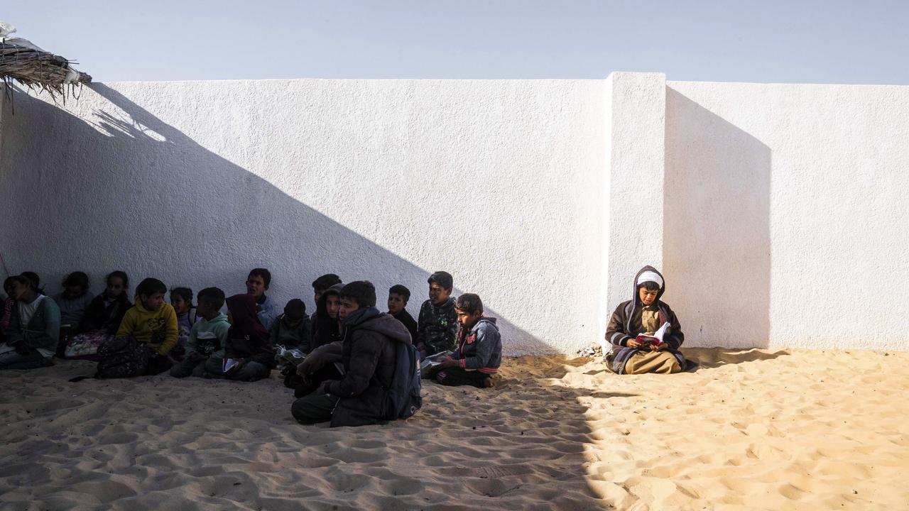 Children read the Koran while waiting for a Ramadan competition in Arish, Egypt. Picture: Ali Moustafa/Getty Images
