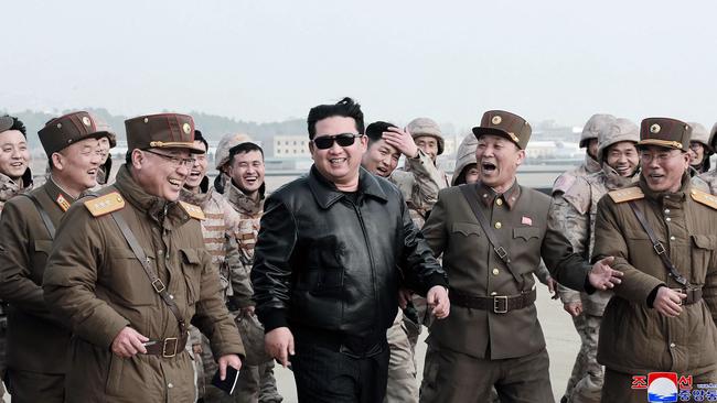 The North Korean leader dons a leather jacket and aviator sunglasses in the video, to the apparent delight of his entourage. Picture: AFP/KCNA via KNS