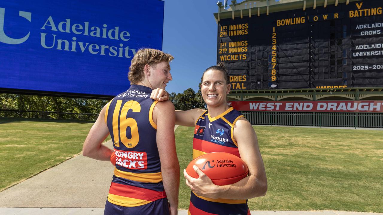 AFL and AFLW players Max Michalanney and Chelsea Randall showing the new Adelaide University logo on their guernsey for 2025. Picture Kelly Barnes