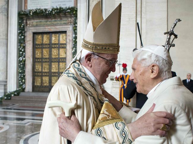 (FILES) This handout file picture released by the Vatican press office shows Pope Francis (L) welcoming Pope emeritus Benedict XVI, on December 8, 2015 in Vatican. - Benedict XVI on February 8, 2022 thanked his successor Pope Francis for his support following allegations the ex-pontiff failed to act against paedophile priests while archbishop of Munich. (Photo by OSSERVATORE ROMANO / AFP)