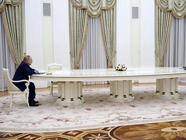 (FILES) In this file photo taken on February 7, 2022, French President Emmanuel Macron (R) meets with Russian President Vladimir Putin (L) in Moscow for talks in an effort to find common ground on Ukraine and NATO, at the start of a week of intense diplomacy over fears Russia is preparing an invasion of its pro-Western neighbour. - Russian leader Vladimir Putin's oversized table has become an unlikely star of diplomatic efforts to ease the Ukraine crisis, and a source of pride for OAK furniture company, the small Italian firm established in Cantu, near Como, that claims to have made it and hopes it will help peace efforts. (Photo by SPUTNIK / AFP)