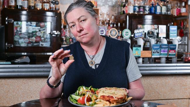 Duke of Brunswick owner Simone Douglas with a $33.50 chicken schnitzel with salad, with each one sold making just a $2 profit. Picture: Brenton Edwards