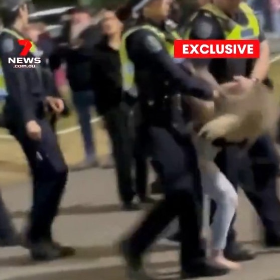 A young woman is led from the Show by police following the brawl. Picture: 7NEWS