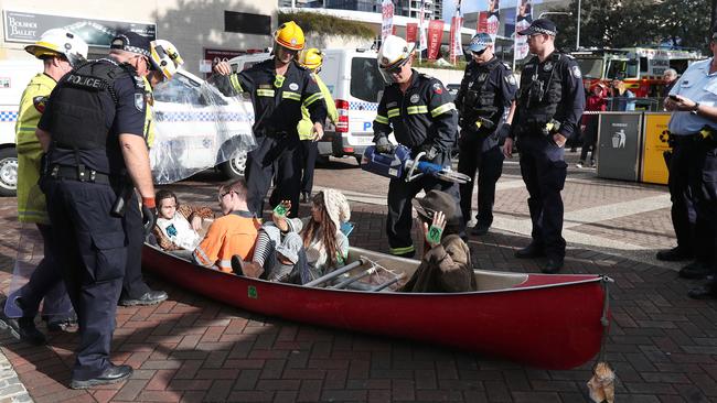 Protesters in a canoe at South Brisbane. Pic Annette Dew