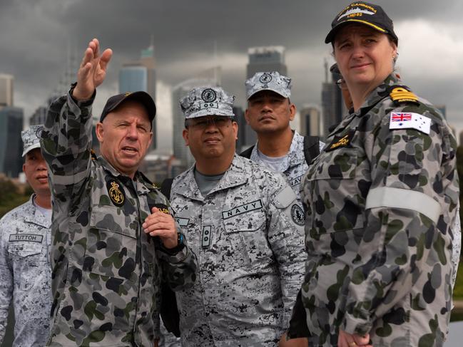 Royal Australian Navy and Philippine Navy officers on the flight deck of HMAS Canberra during a Maritime Training Activity. Picture: Australian Defence Force