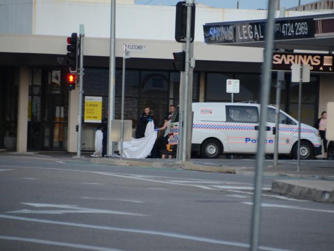 The police at the scene of the deceased body on the corner of Flinders St and Fletcher St.