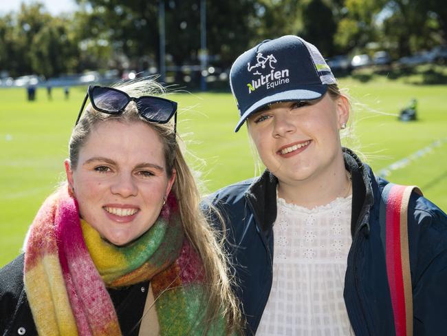 Evie Moore (left) and Abbey Palmer support Grammar on Grammar Downlands Day at Toowoomba Grammar School, Saturday, August 19, 2023. Picture: Kevin Farmer